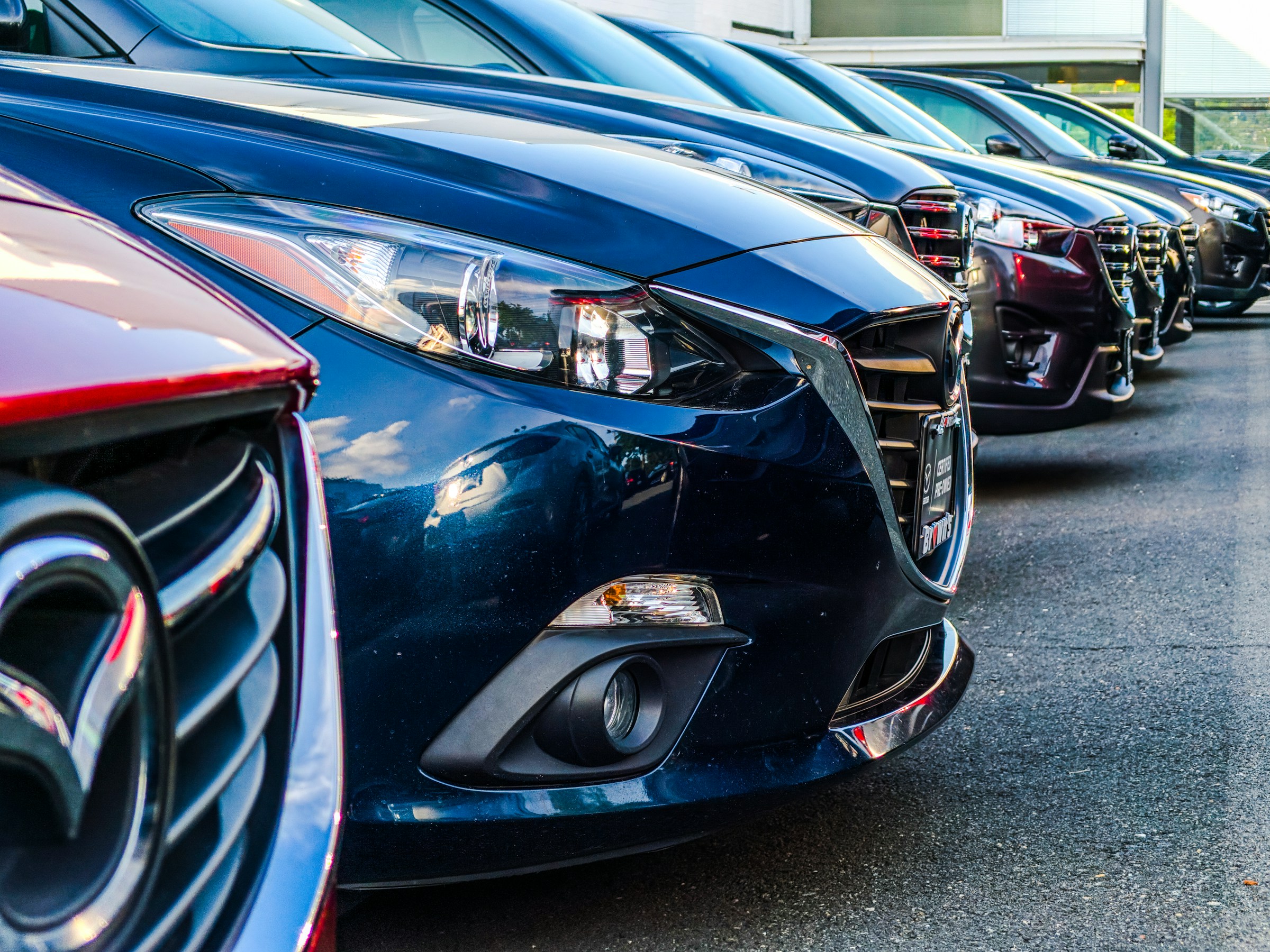 Image of several cars parked in a row.